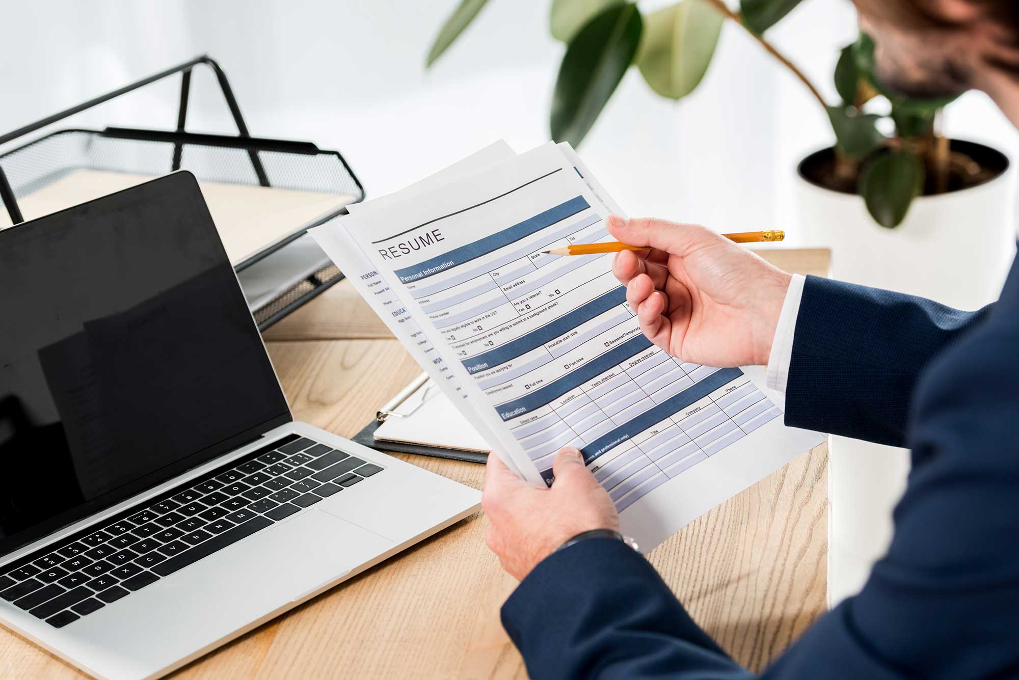 selective-focus-of-man-holding-resume-and-pencil-n-2023-11-27-05-09-38-utc.jpg
